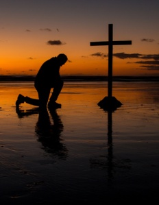 Kneeling Before The Cross